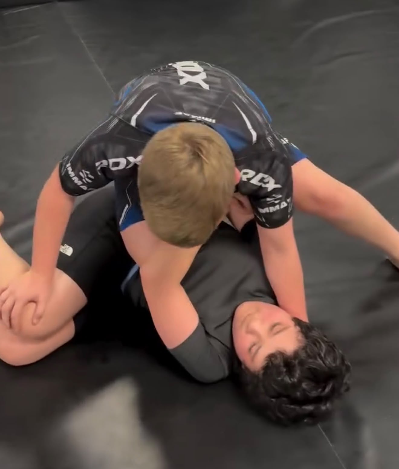 Junior grapplers working a pin during no-gi class