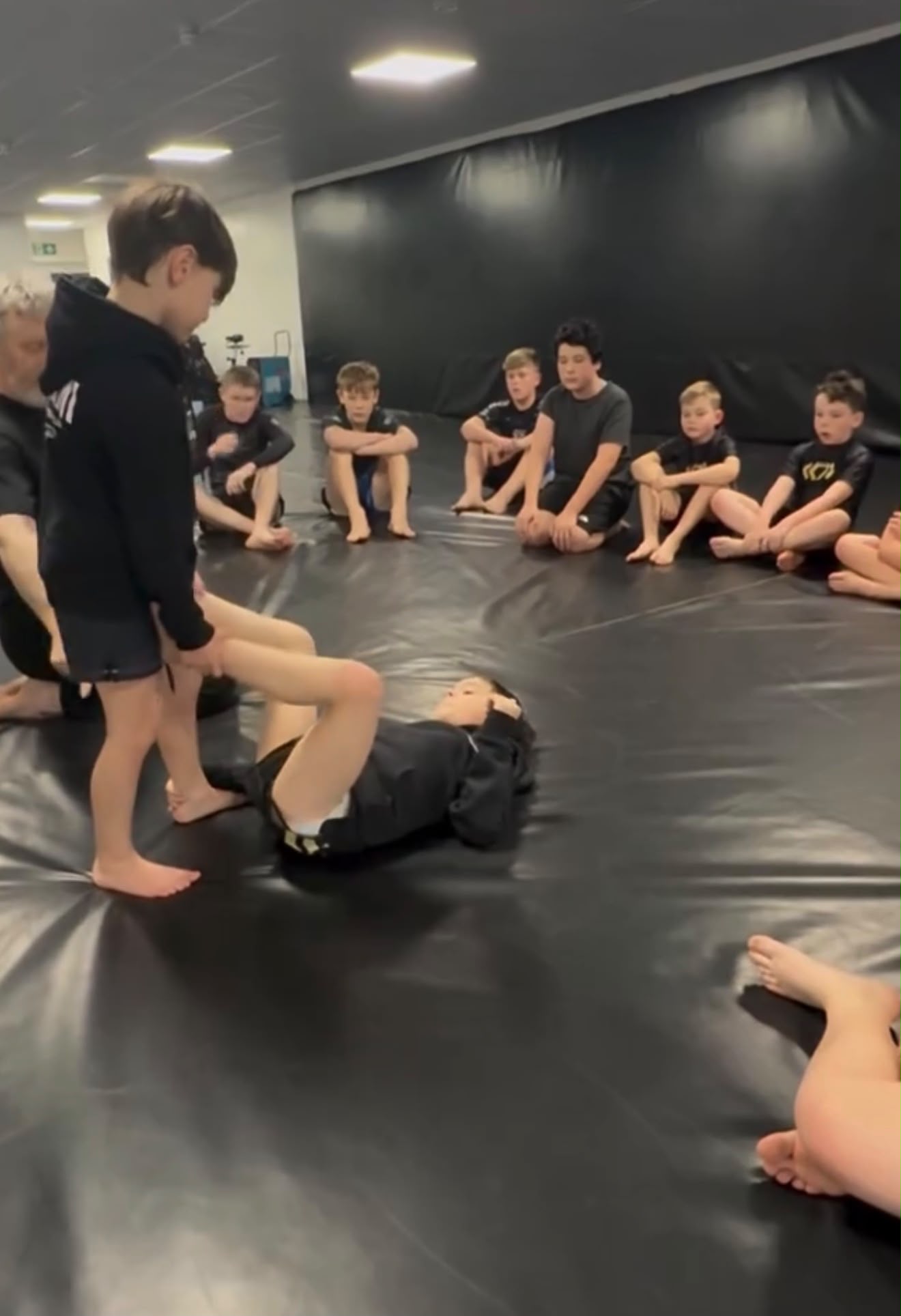 Coach demonstrating a technique while the juniors watch